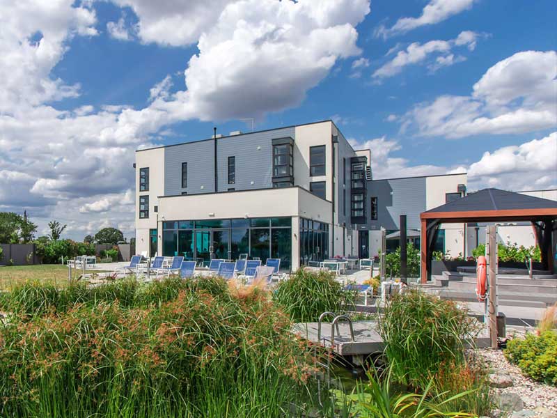 Modern building with lush greenery.